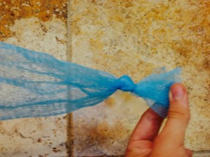 Tie a double knot near one end of the tube.