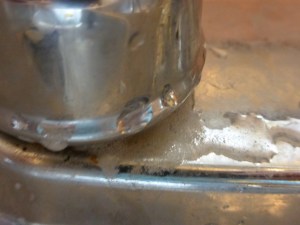 faucet base, gunk bubbling out